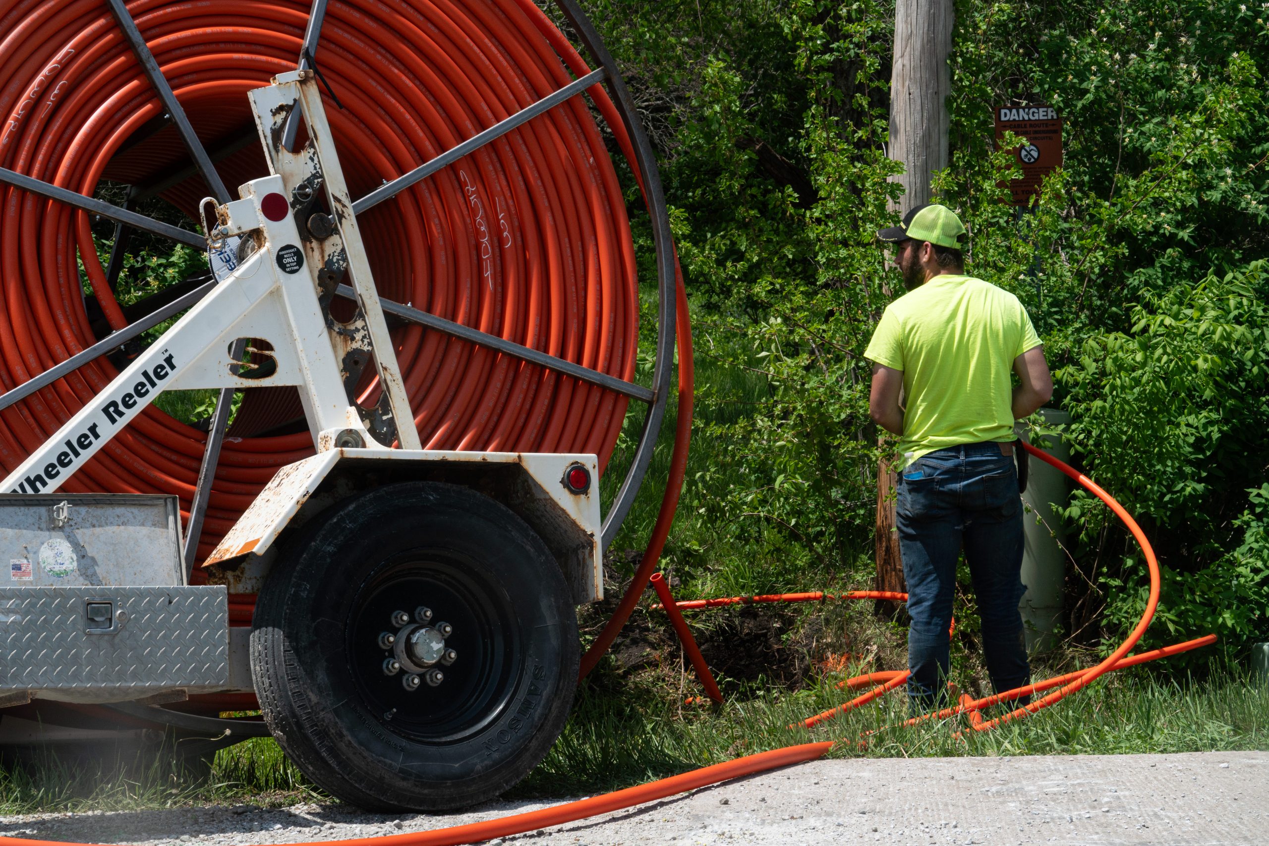 Fiber conduit spool on trailer at construction site