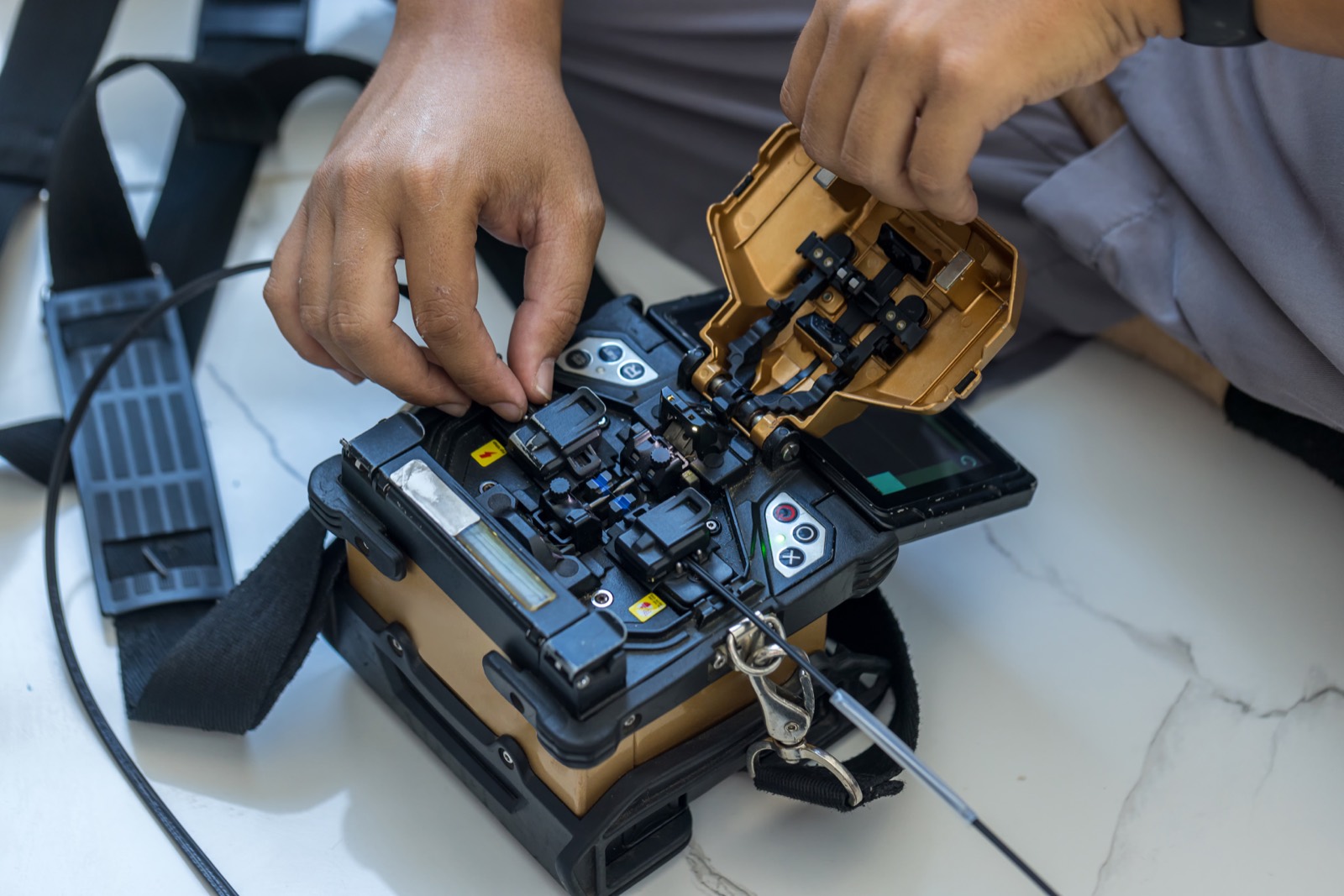 Technician working with a fiber optic fusion splicer